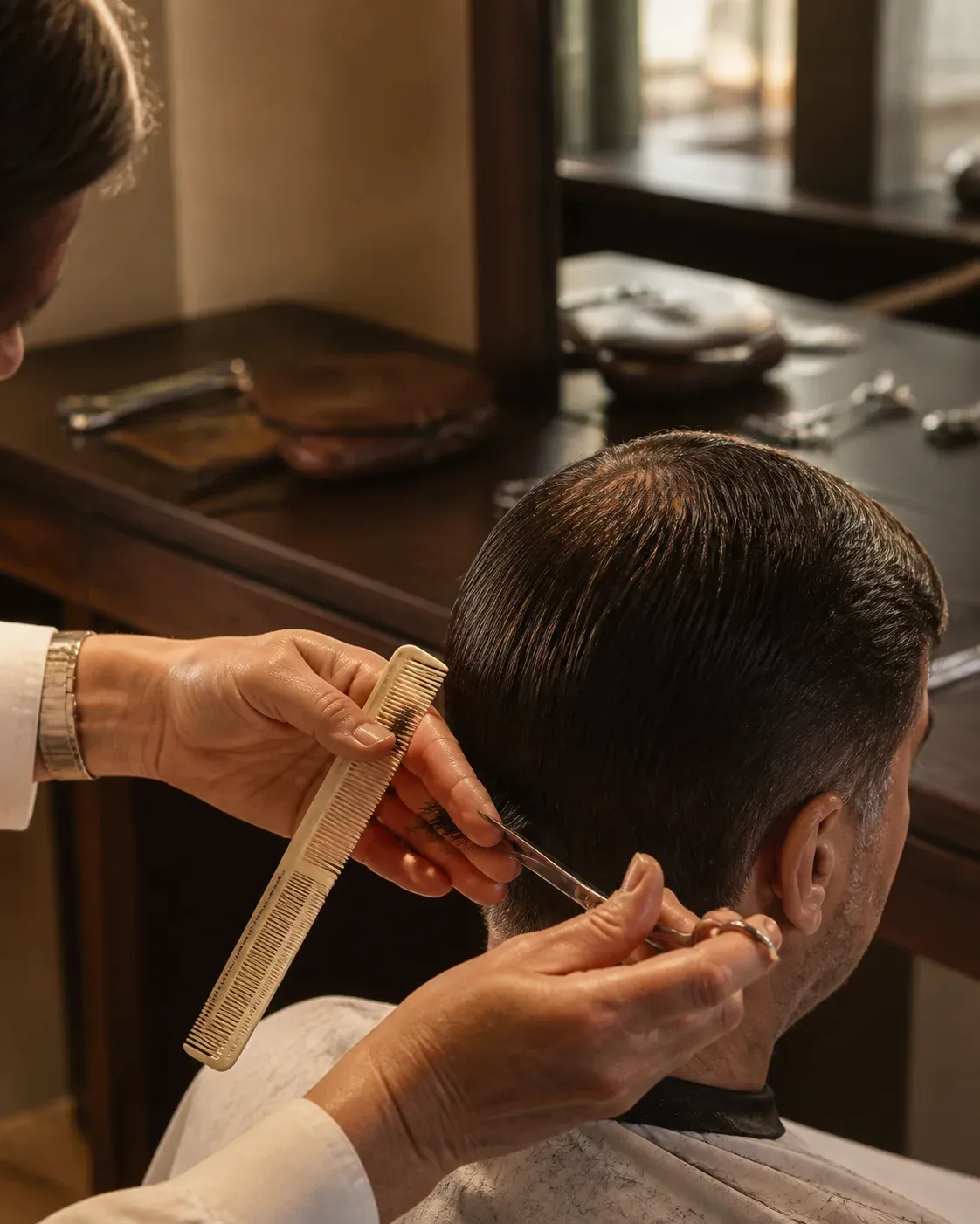 A stylist carefully finishing a precision haircut