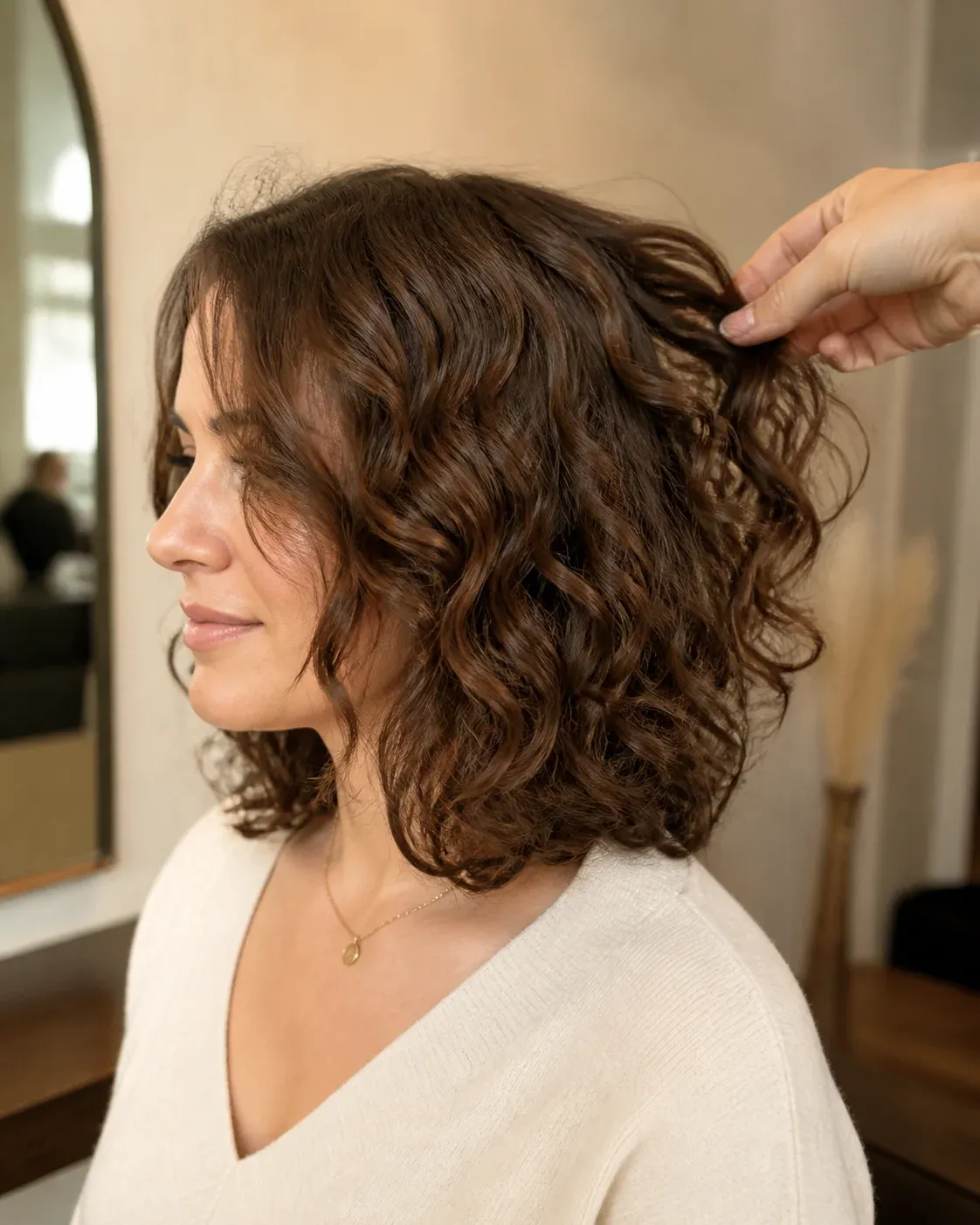 Naturally defined curls being styled by a professional