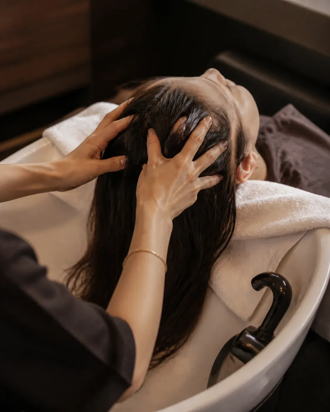 Relaxing hair treatment at a salon basin