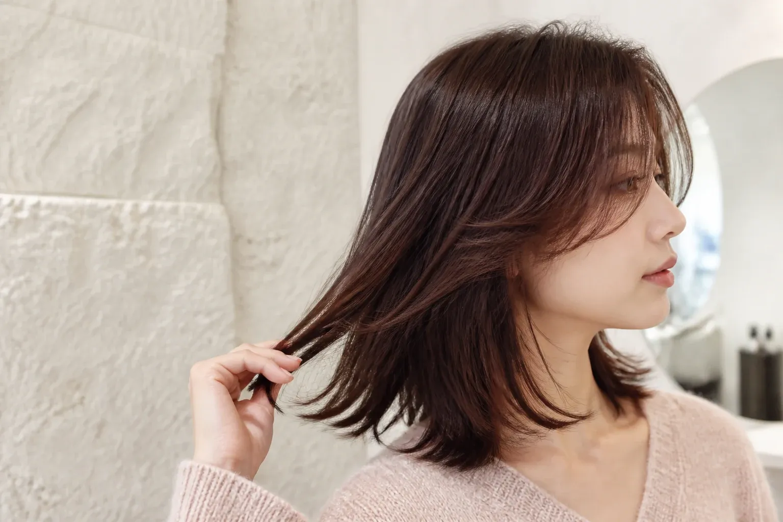 Fresh layered haircut being considered in the salon